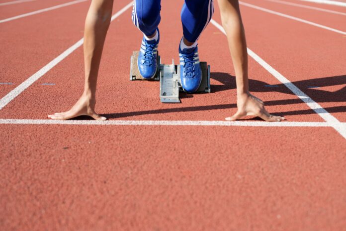 Close-up of an athlete waiting to start a race at the track field.